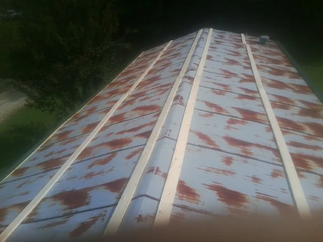 Rusted metal roof panels with new wood purlins before replacement — Storm Damage Roof Repair in Hobe Sound by Roofing Brothers